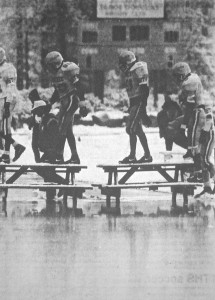 Truckee players use picnic tables to cross the field which was under more than 3 inches of water.