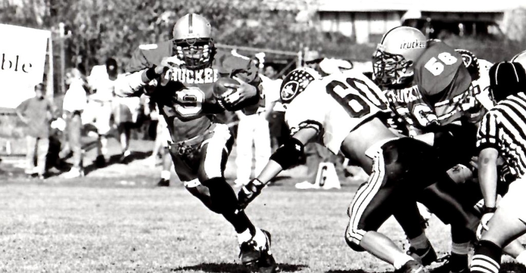 Sophomore James VanBrunt gets a big block from fellow sophomore Kris wicks to spring for a big run versus rival North Tahoe.