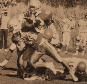 (34) Shawn Stock fights for yardage during the home opener vs Quincy