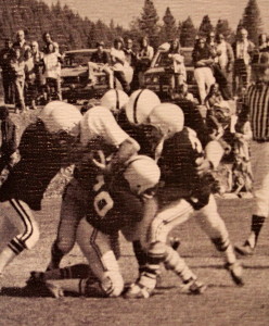 Truckee defenders swarm to the ball. Apparently Surprise Stadium was yet fenced in as there are cars parked up in the visiting embankment 