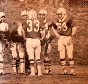 (33) Rusty Tracy leads the team out of the end zone (53) Herb Copeland waits for the call. 