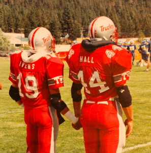 (19) Josh Ivens and (44) Jevon Hall await the coin toss. 1991 was the first year the captains joined hands as a sign of "Family" walking out to the coin toss. 