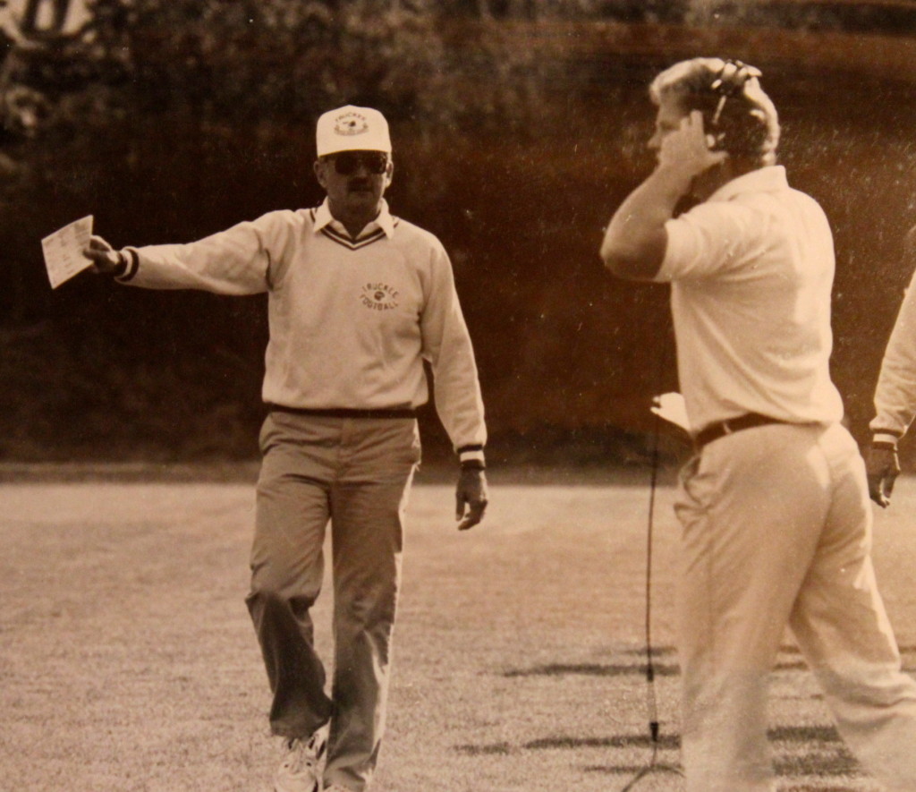 Coach Estabrook discusses strategy with Coach McGovern